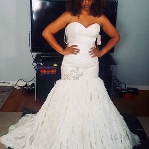 This is a Demetrois wedding dress with a trumpet silhouette.